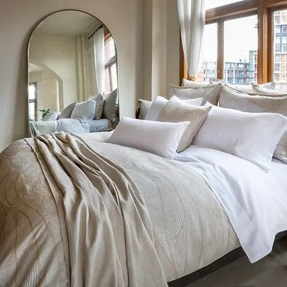 Saturna Jacquard Duvet Cover styled on a bed with pillows – 74% Cotton / 26% Linen, Fabric from Italy by St. Genève