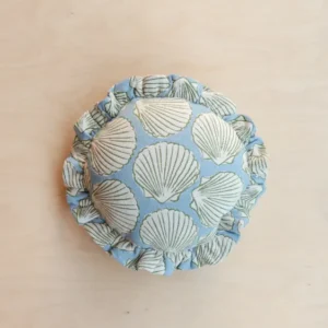 Portrait view of TBCo Cotton Cushion Cover in Blue Shell featuring soft round shape and delicate ruffled edge, gallery position 1.