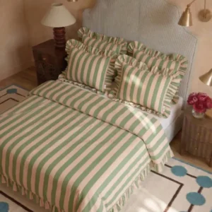Cotton Duvet Cover & Pillowcases Set in Green Stripe by TBCo with ruffled edges styled on bed with soft pastel décor