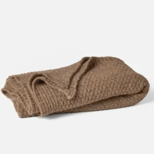 Coyuchi Cordillera Alpaca Cotton Knit throw in camel, folded to show waffle texture.
