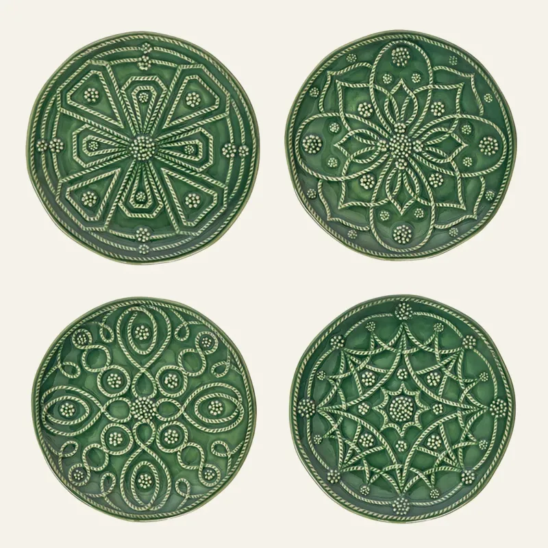 Juliska Jardins Du Monde four green ceramic cocktail plates with embossed floral patterns.