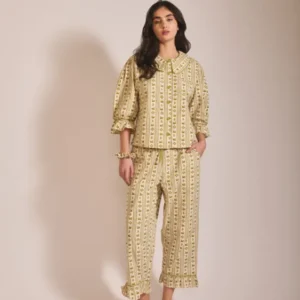 Model wearing TBCo Cropped Cotton Pyjamas in Olive Swan with puff sleeves and ruffle detail on cropped trousers