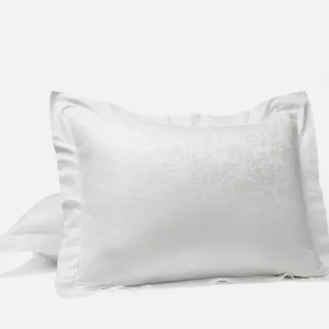 Coyuchi Heirloom Sateen Jacquard pillow sham in white with floral jacquard detail.