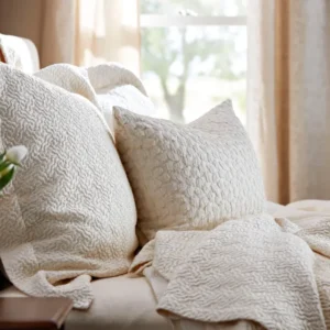 SDH Purists Allegro ivory jacquard coverlet and shams on a sunlit bed.
