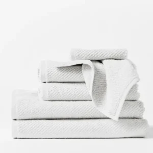 Coyuchi Air Weight Oversized Hand Towel in white, stacked set with ribbed texture detail.