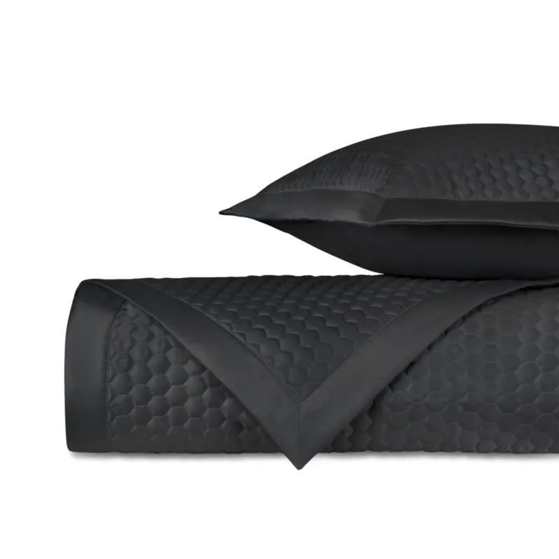 Home Treasures Apiary quilted coverlet and euro sham set in black with honeycomb texture.