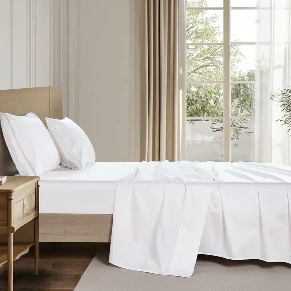 Organic cotton sheet set on a styled bed, soft breathable and naturally hypoallergenic